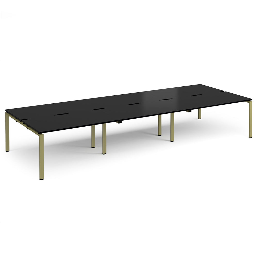 Long back-to-back desk with black top and green metal frame on a white background
