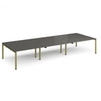 Long back-to-back desk with grey top and green metal frame on a white background