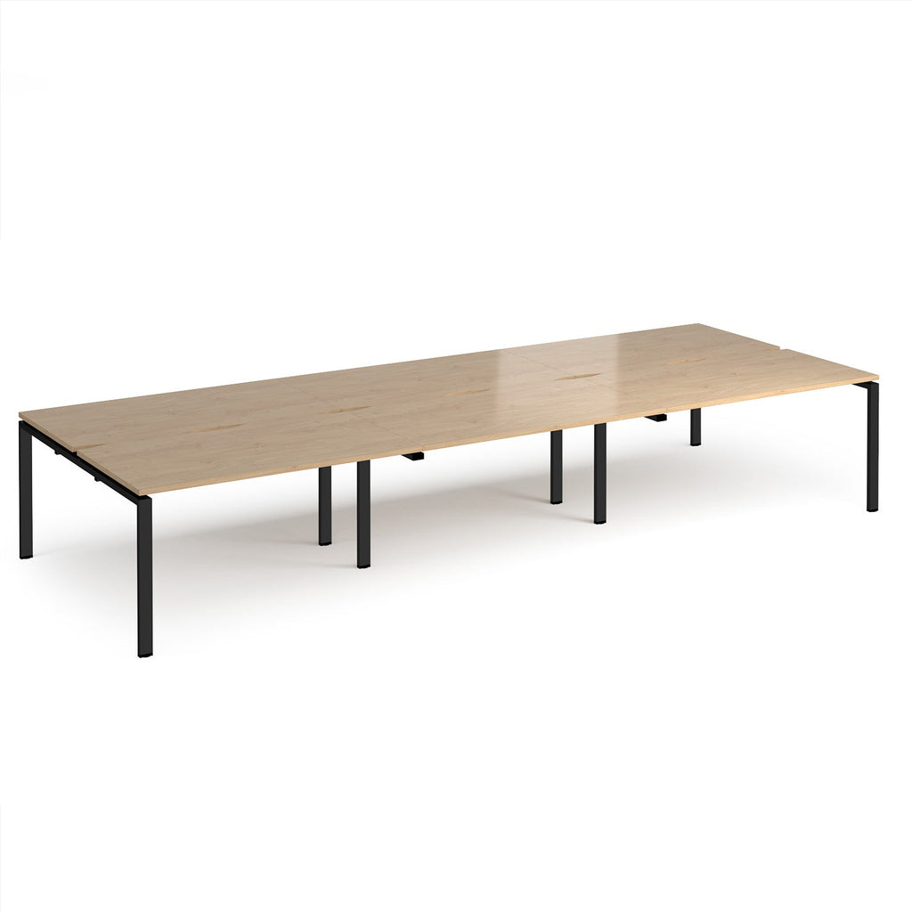 Long back-to-back desk with wood-effect top and black metal frame on a white background