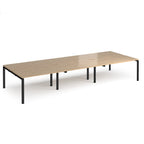 Long back-to-back desk with wood-effect top and black metal frame on a white background