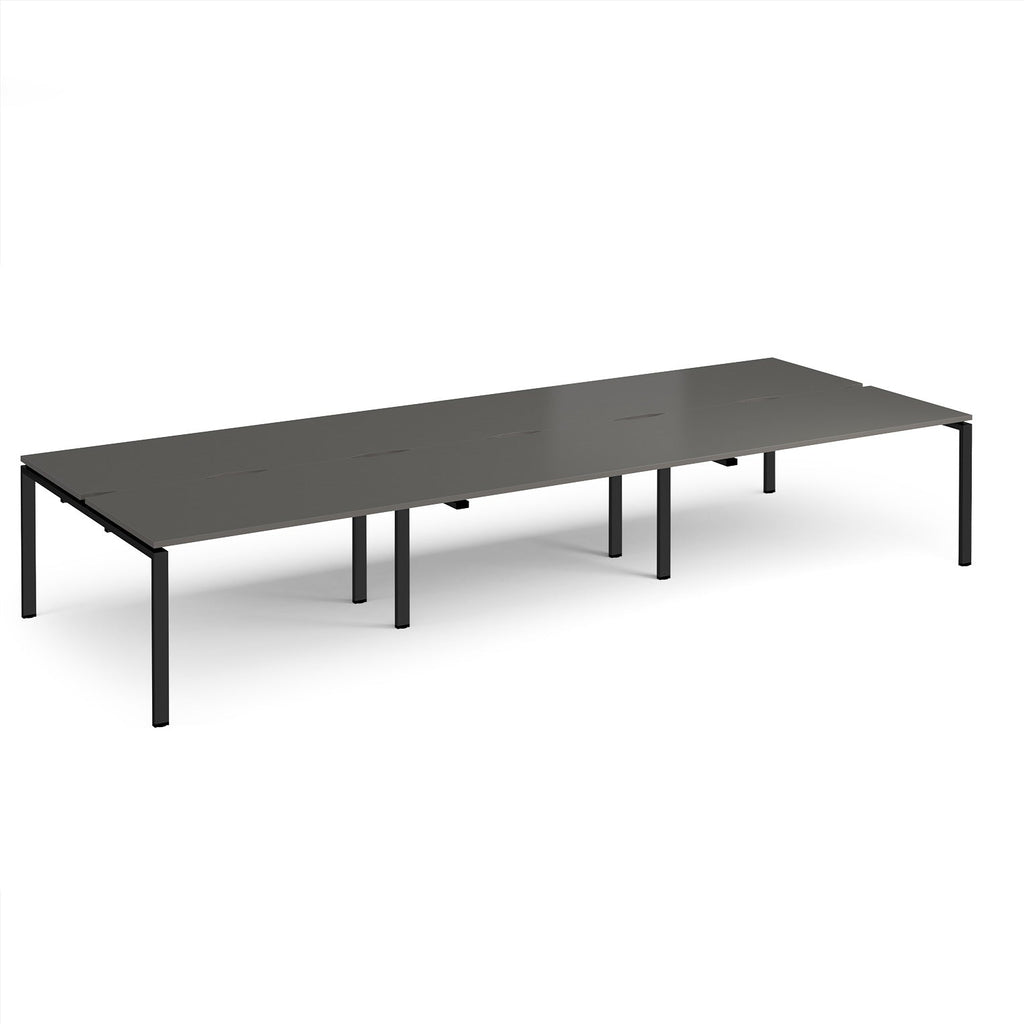 Long back-to-back desk with grey top and black metal frame on a white background