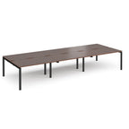 Long back-to-back desk with wood-effect top and black metal frame on a white background