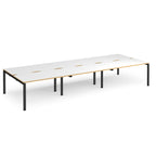 Long back-to-back desk with white top with wooden edges and black metal frame on a white background
