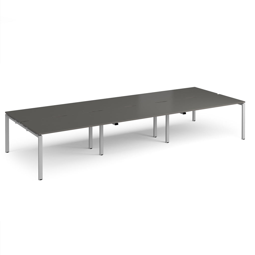 Long back-to-back desk with grey top and silver metal frame on a white background