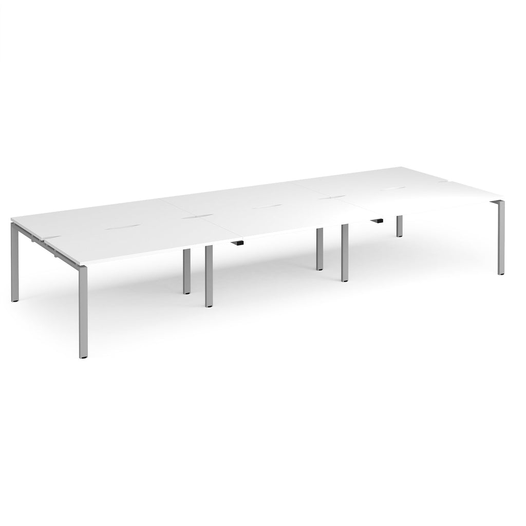 Long back-to-back desk with white top and silver metal frame on a white background