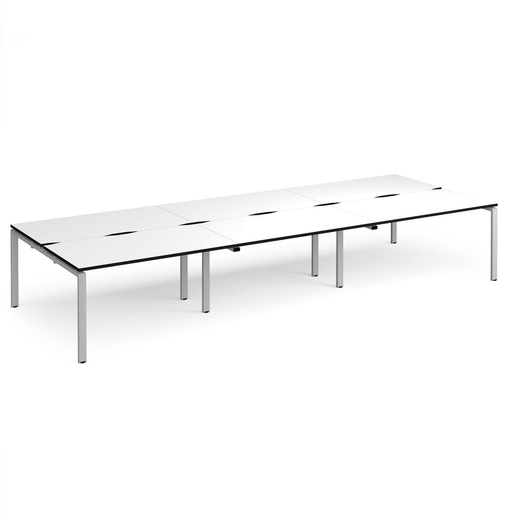 Long back-to-back desk with white top with black edges and silver metal frame on a white background