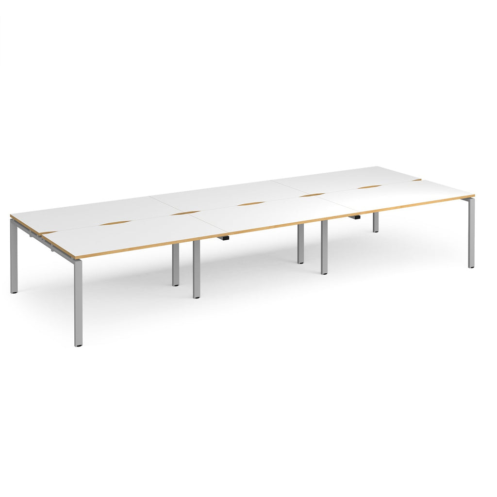 Long back-to-back desk with white top with wooden edges and silver metal frame on a white background