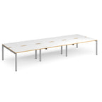 Long back-to-back desk with white top with wooden edges and silver metal frame on a white background