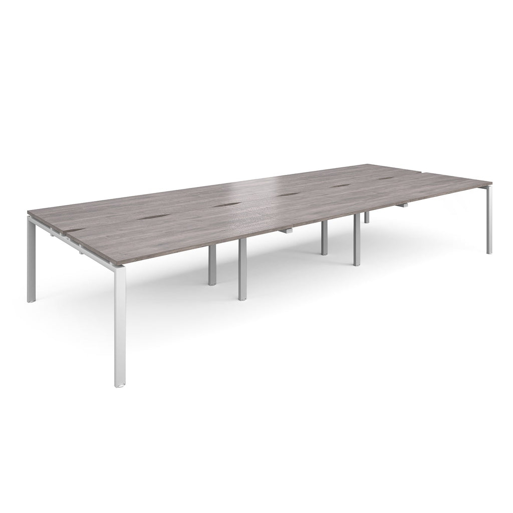 Long back-to-back desk with grey wood-effect top and white metal frame on a white background