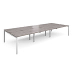 Long back-to-back desk with grey wood-effect top and white metal frame on a white background