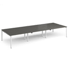 Long back-to-back desk with wood-effect top and black metal frame on a white background