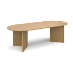 Oval-shaped wood-effect conference table on a white background