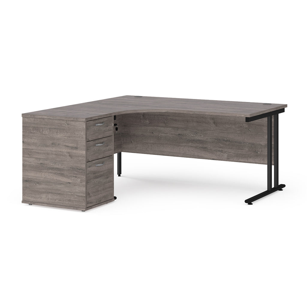 Wooden corner desk with metal legs and matching pedestal on a white background