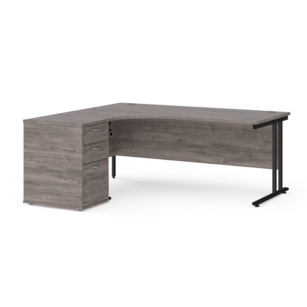 Wooden corner desk with metal legs and matching pedestal on a white background