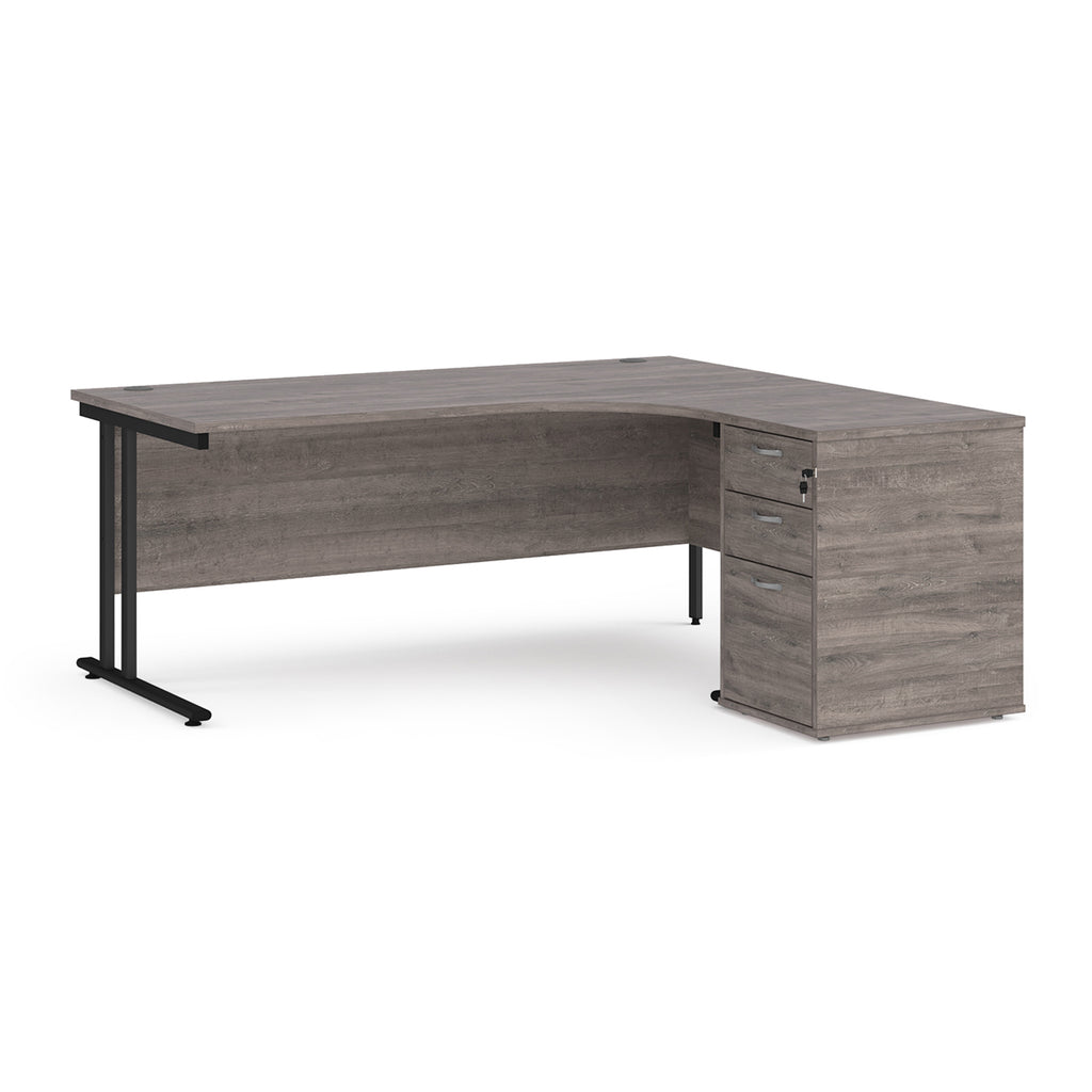Wooden corner desk with metal legs and matching pedestal on a white background