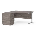 Wooden corner desk with metal legs and matching pedestal on a white background