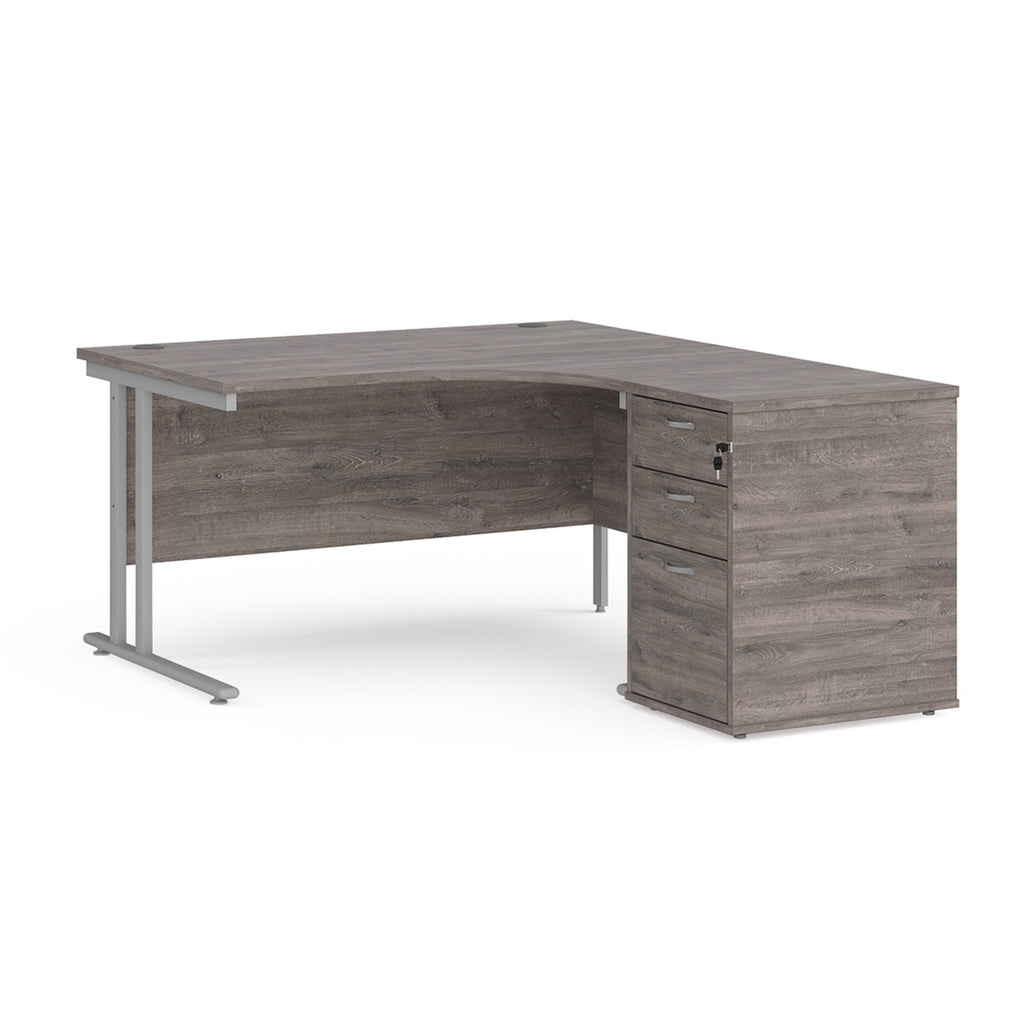 Wooden corner desk with metal legs and matching pedestal on a white background
