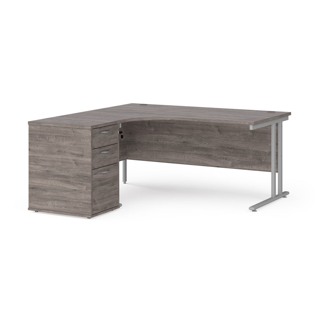 Wooden corner desk with metal legs and matching pedestal on a white background