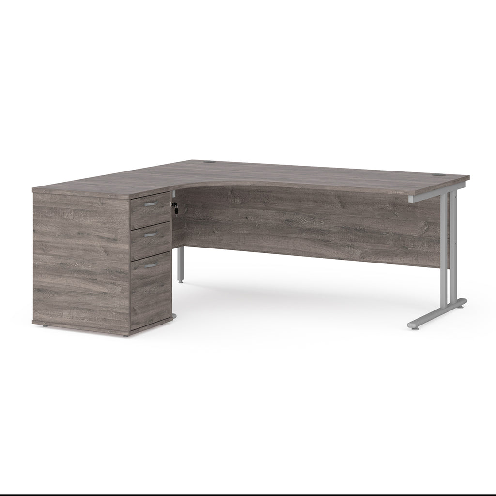 Wooden corner desk with metal legs and matching pedestal on a white background
