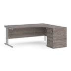 Wooden corner desk with metal legs and matching pedestal on a white background