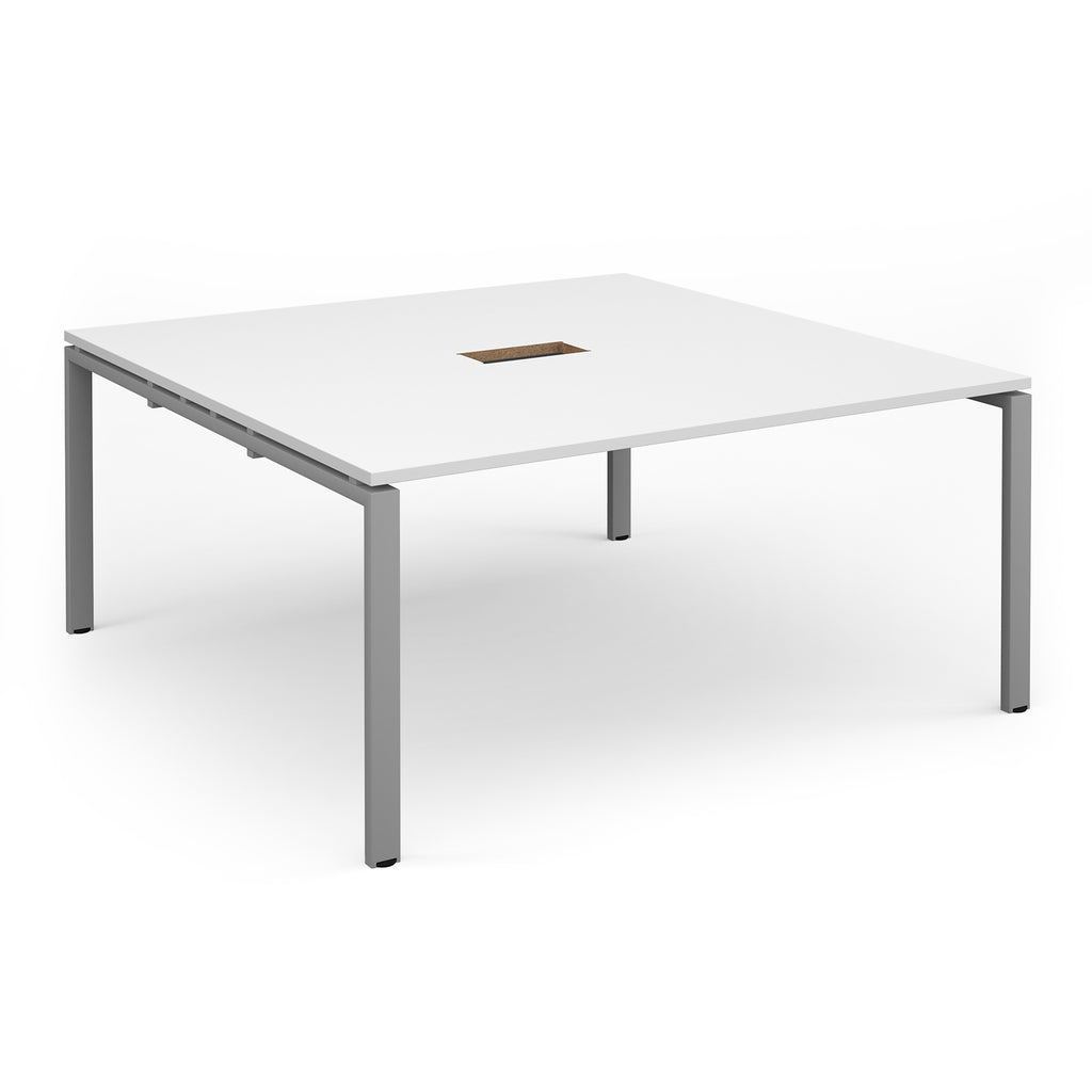 Square table with white top with central cut-out and silver metal frame on a white background
