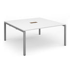 Square table with white top with central cut-out and silver metal frame on a white background