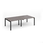 A rectangular modern table with a dark grey wood-grain top and black metal legs, shown on a clean white background.