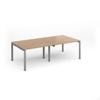 A rectangular office table with a light wood grain top and slim silver metal legs, shown on a clean white background.