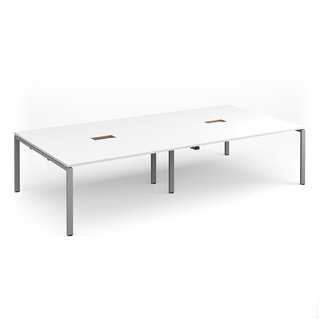 Rectangular meeting table with white top with two cut-outs and silver metal frame on a white background