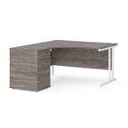 Wooden corner desk with metal legs and matching pedestal on a white background