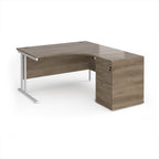 Wooden corner desk with metal legs and matching pedestal on a white background