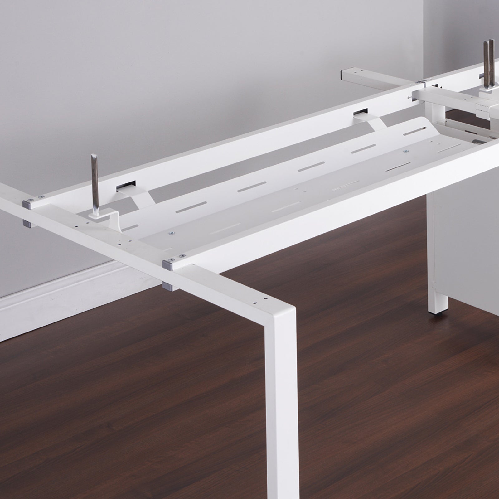 White metal office desk frame on a wooden floor