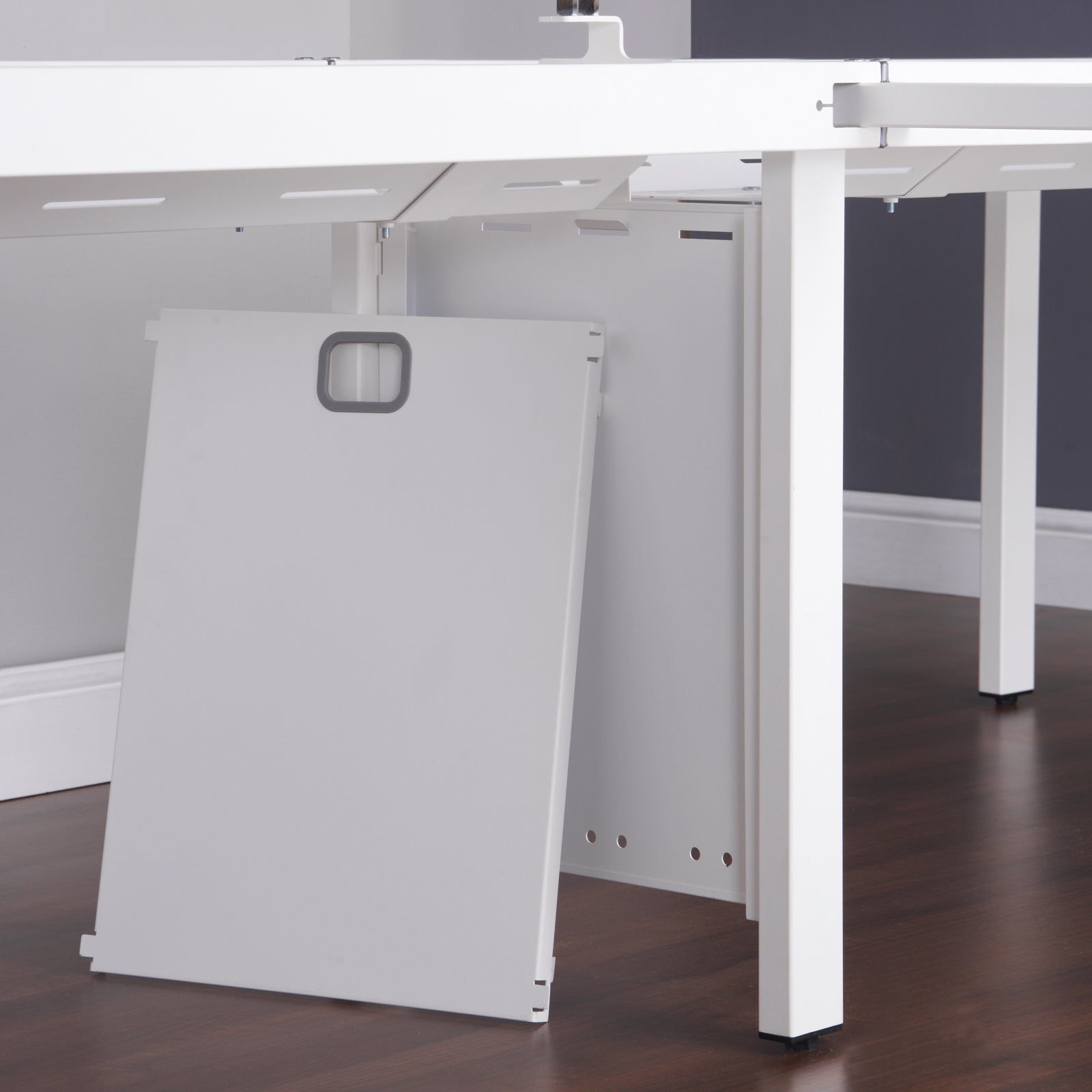 White office desk with a cable riser in an office setting