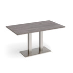 A rectangular dining table with a grey wood-grain top and a modern brushed steel metal pedestal base, shown on a clean white background.