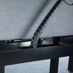 Metal chain running through a black metal frame on a grey background