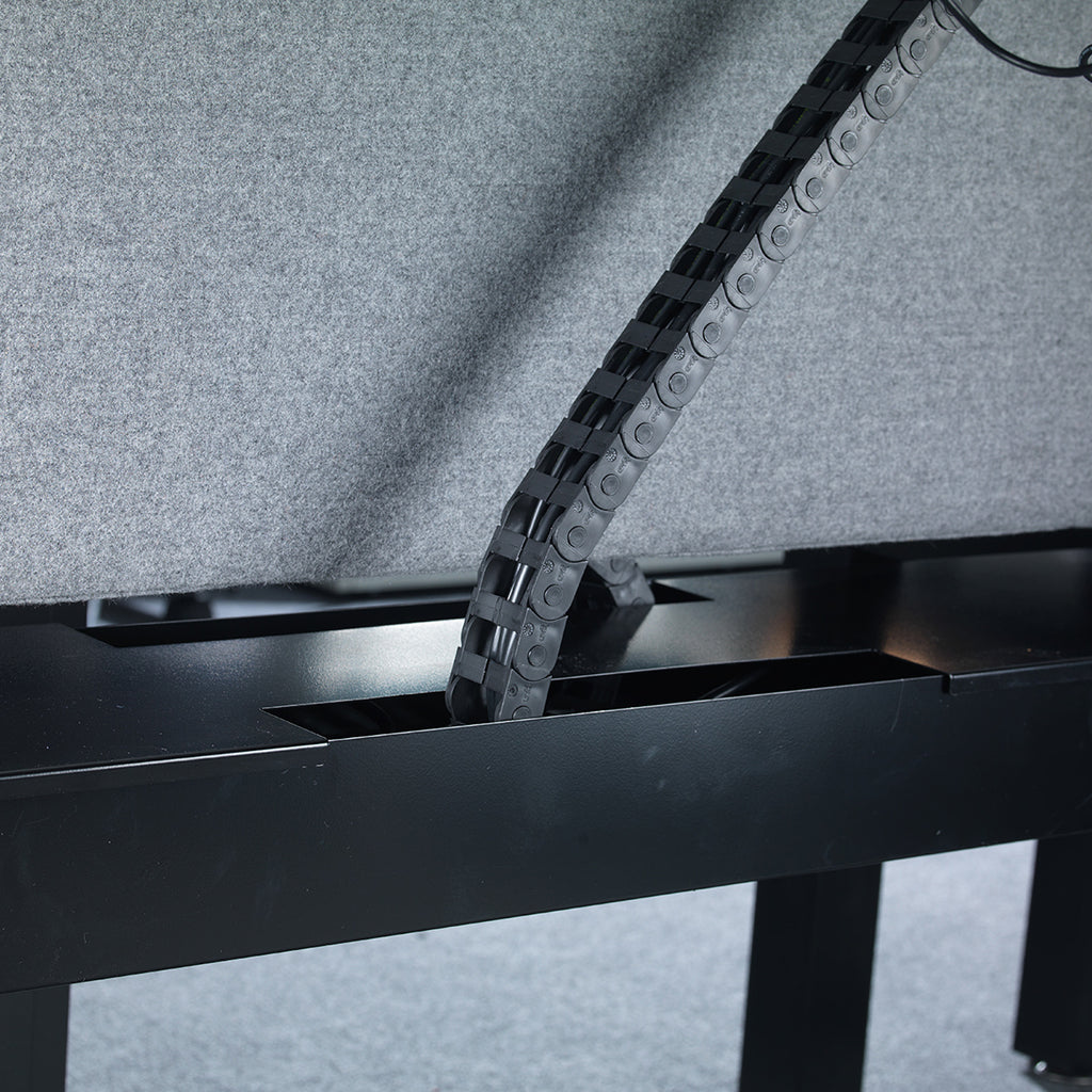 Metal chain running through a black metal frame on a gray background