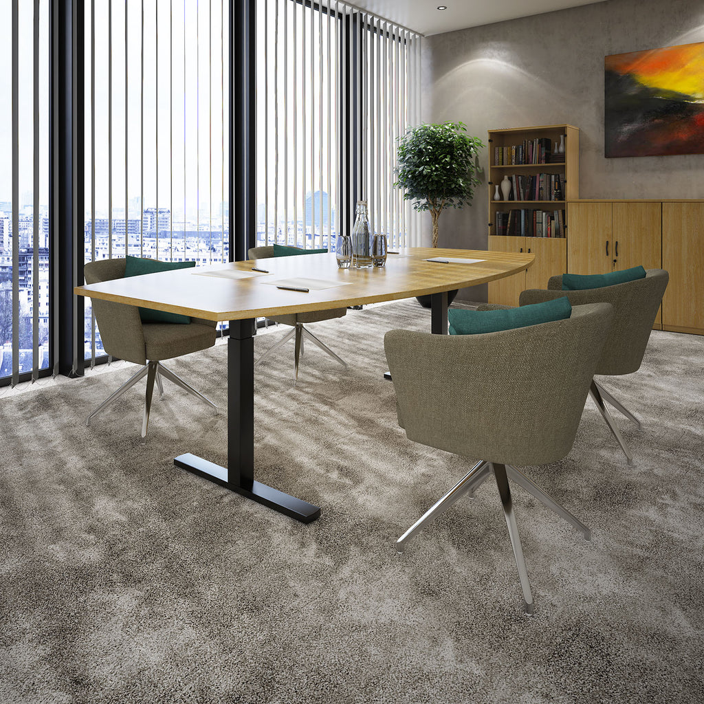 A modern meeting room setup featuring a rectangular light wood table with a black metal pedestal base, surrounded by four upholstered swivel chairs with grey fabric and teal cushions, set on a textured grey carpet in a contemporary office.