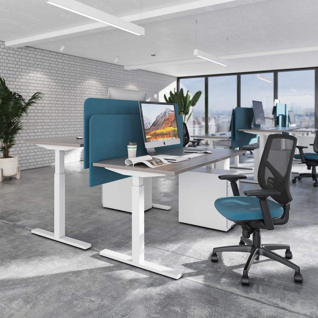 Modern office setup with a desk, chair, and computer monitor in a bright room.