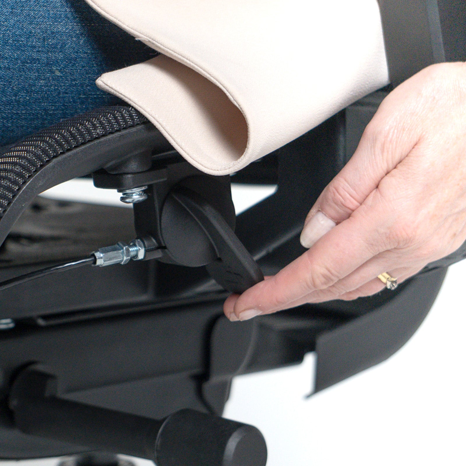 Close-up of a hand adjusting a component on a stroller.