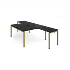 L-shaped back-to-back desks with black top and a green metal frame on a white background