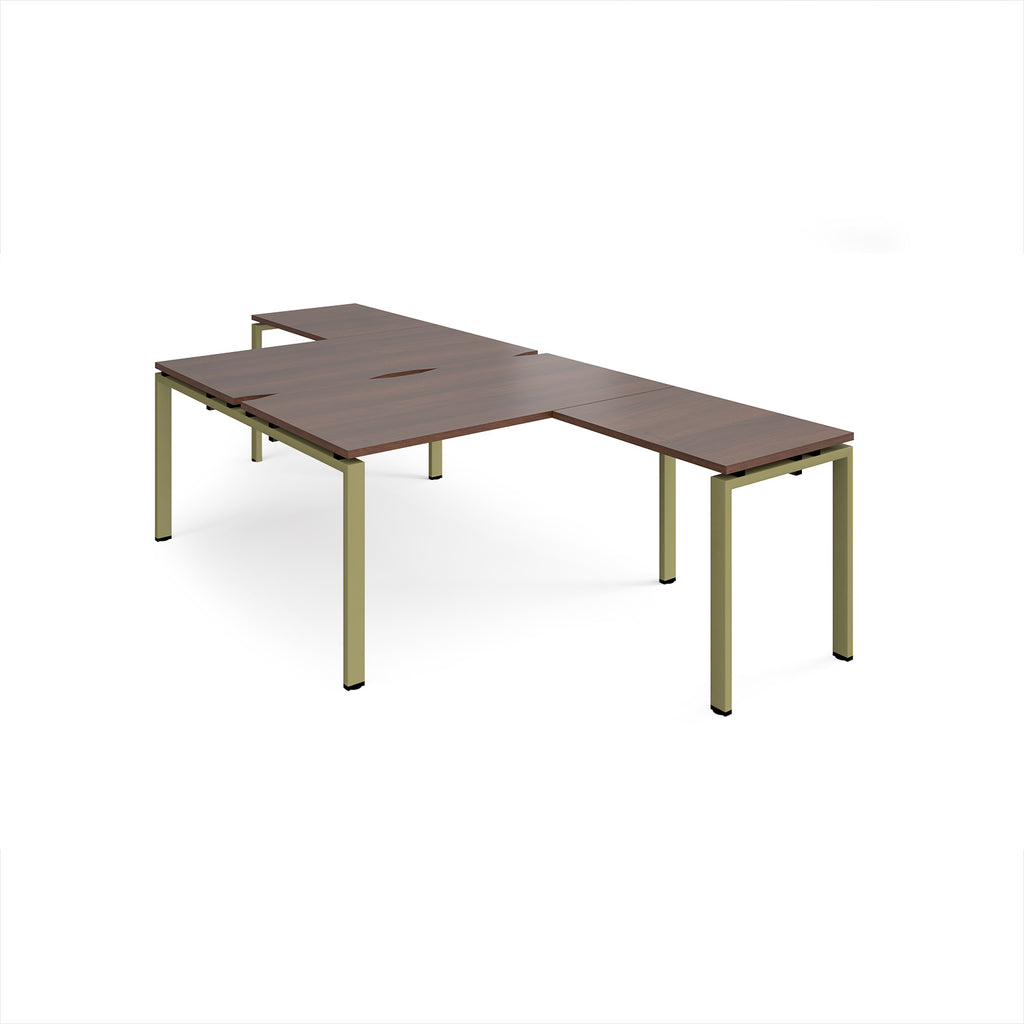 L-shaped back-to-back desks with wood-effect top and a green metal frame on a white background