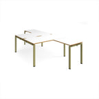 L-shaped back-to-back desks with white top with wooden edges and a green metal frame on a white background