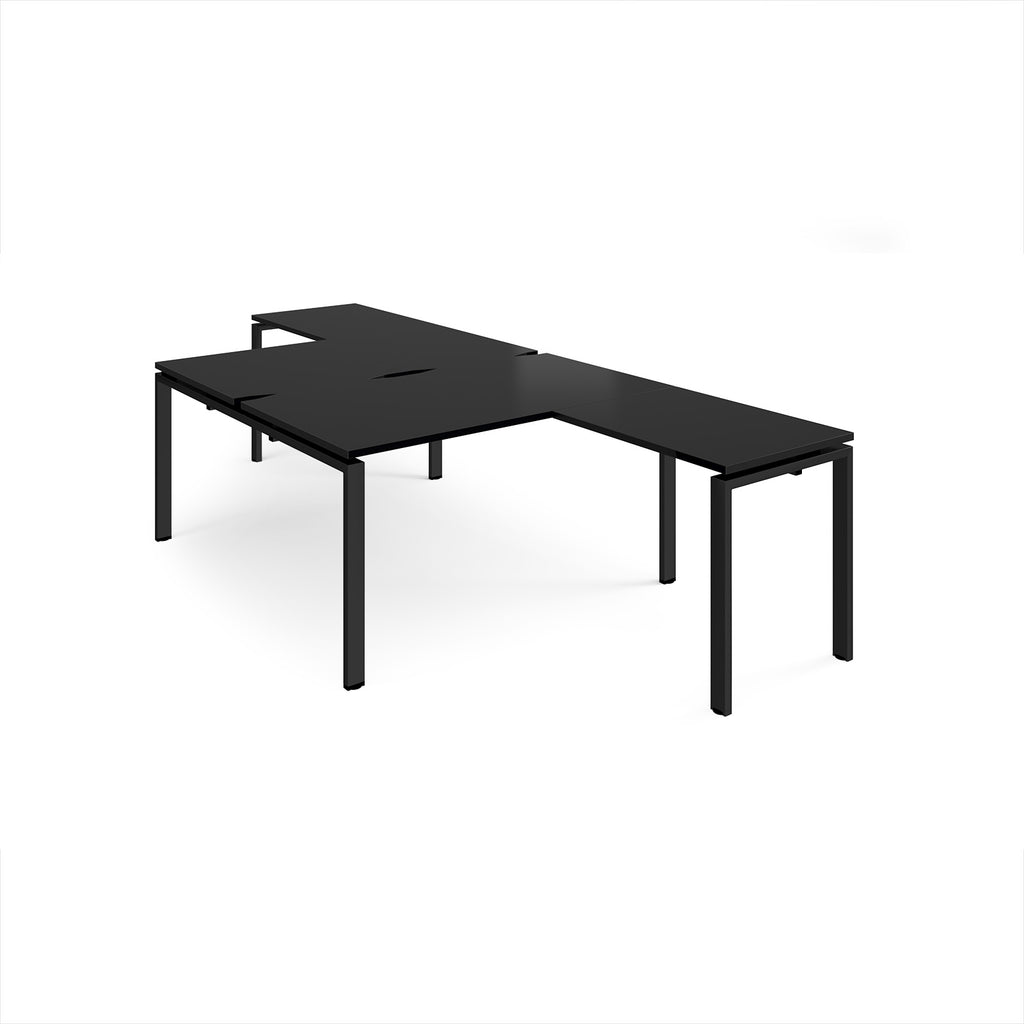 L-shaped back-to-back desks with black top and a metal frame on a white background