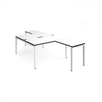 L-shaped back-to-back desks with white top with black edges and a white metal frame on a white background