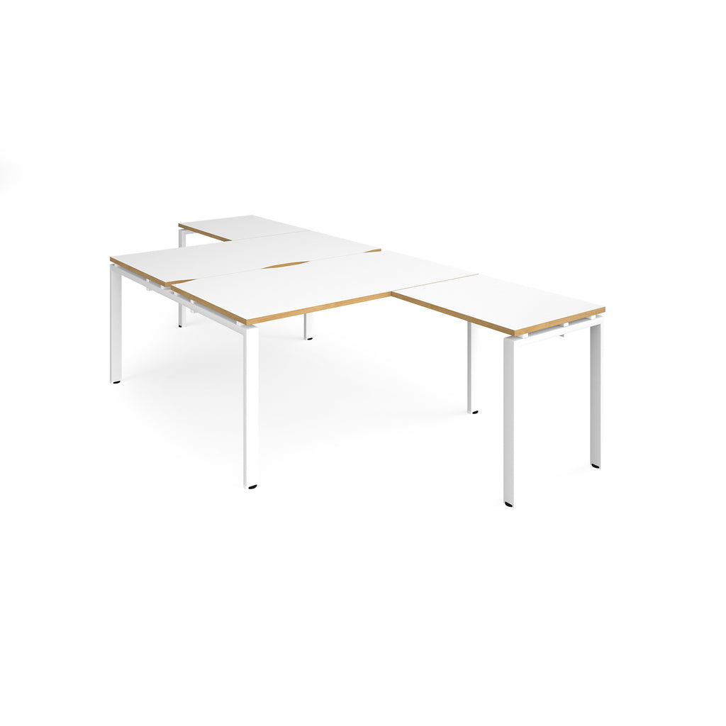 L-shaped back-to-back desks with white top with wooden edges and a white metal frame on a white background