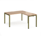 L-shaped desk with wood-effect top and green metal frame on a white background