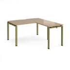 L-shaped desk with wood-effect top and green metal frame on a white background