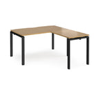 L-shaped desk with wood-effect top and black metal frame on a white background