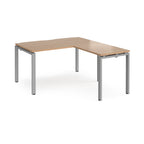 L-shaped desk with wood-effect top and silver metal frame on a white background