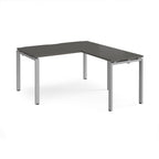 L-shaped desk with grey top and silver metal frame on a white background
